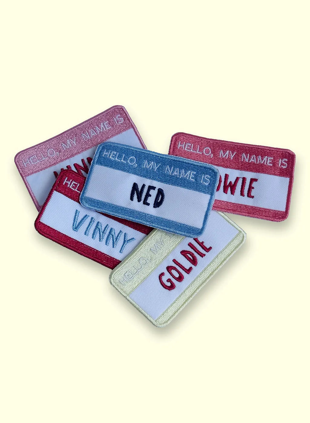 Collection of name tag patches with names 'Ned', 'Vinny', and 'Goldie' on a white background.